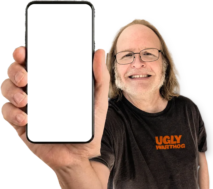 Photo of Mike Hughes in a dark Ugly Warthog tee, holding up a phone with the sample septic homepage on it