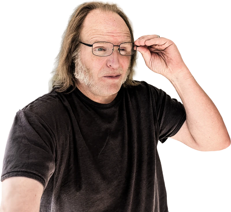 Mike Hughes lifting his glasses and squinting at the camera